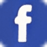 A white facebook logo on a blue background.